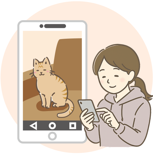 スマホでペットを見る女性の図
